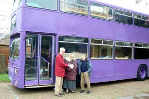 Donation being presented to Foodshare, in front of the bus that they use to provide accomodation