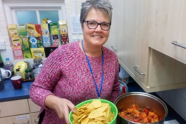 Angela, Quaker chaplain to Reading University, serves vegetarian chilli to students